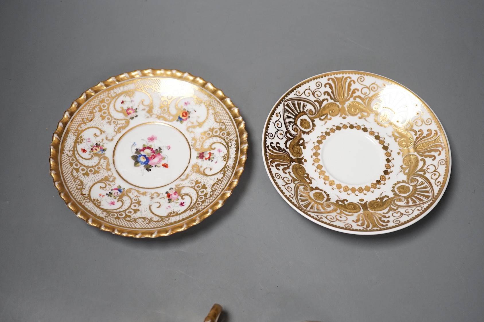 A Chamberlains Worcester gadroon bordered coffee cup and saucer painted with flowers, printed mark in puce and a Spode teacup and saucer with raised gilding in neo-classical style pattern 4327, mark and pattern in red